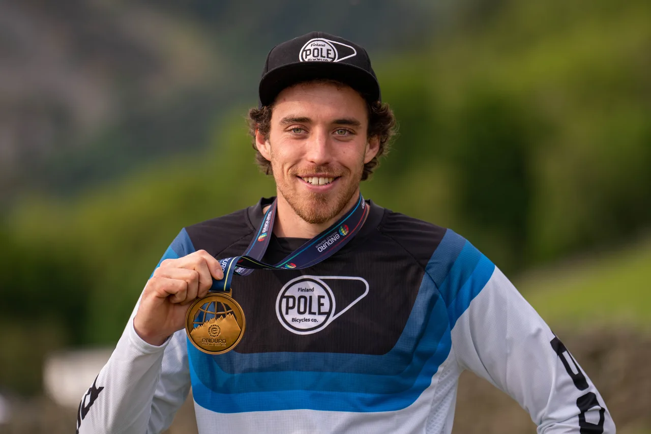 Leigh Johnson with his third-place medal at the EWS-E opener in Tweed Valley, 2022